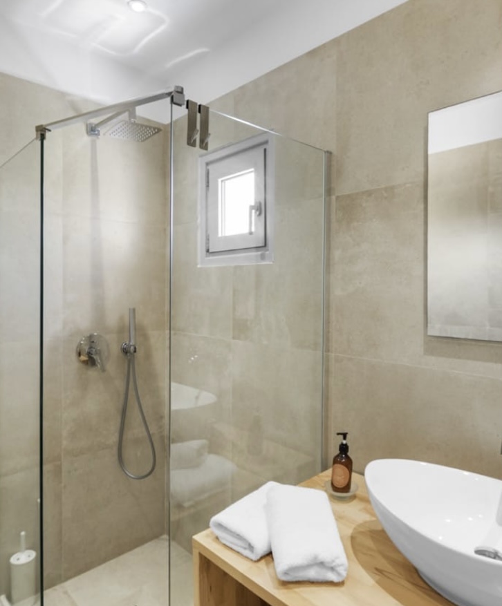 Bathroom with rain shower and stone tiling
