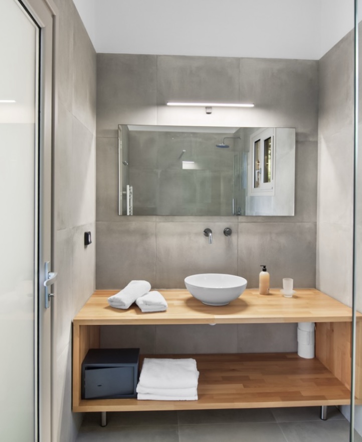 Bathroom with wooden vanity and rain shower