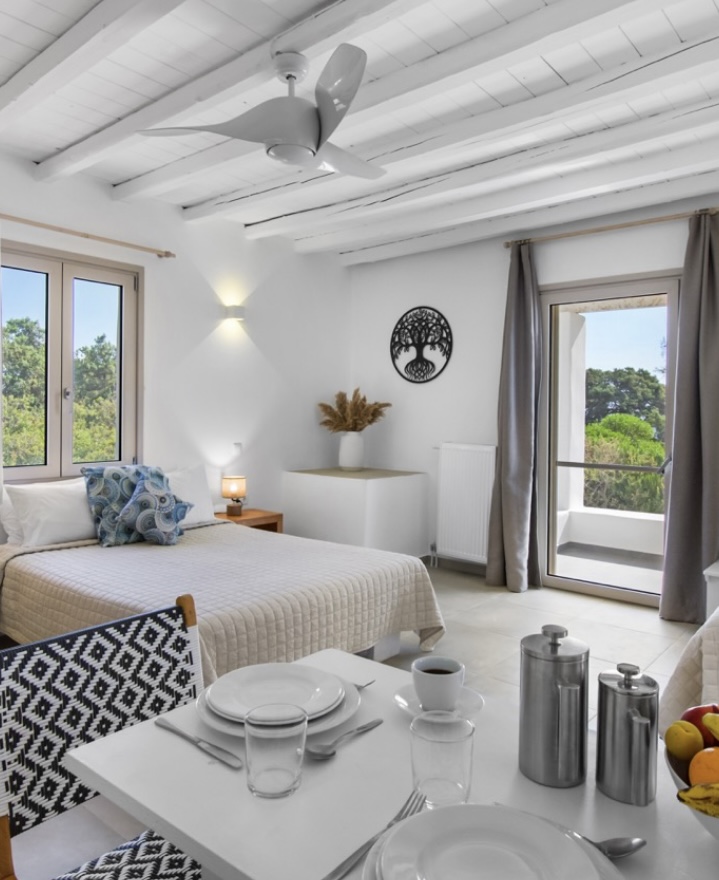 Studio with double bed, dining table and balcony views