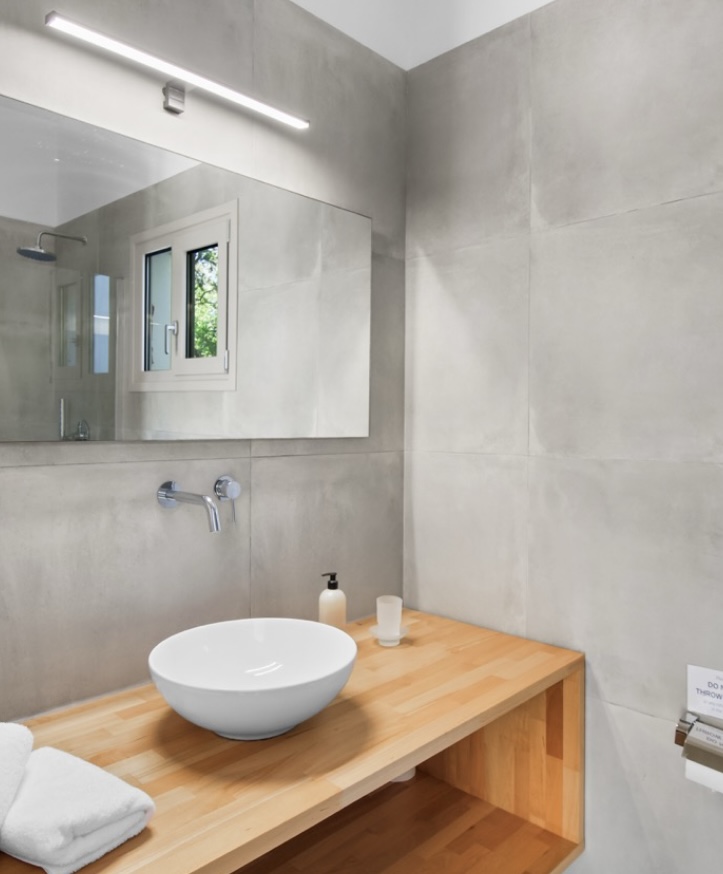 Bathroom detail with stone walls and wooden vanity