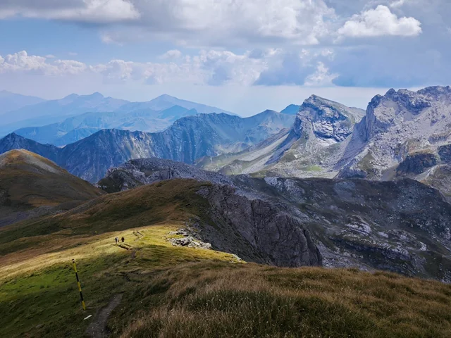 Hikers on a ridge trail with the Golem Korab mountains of Mavrovo National Park in the distance