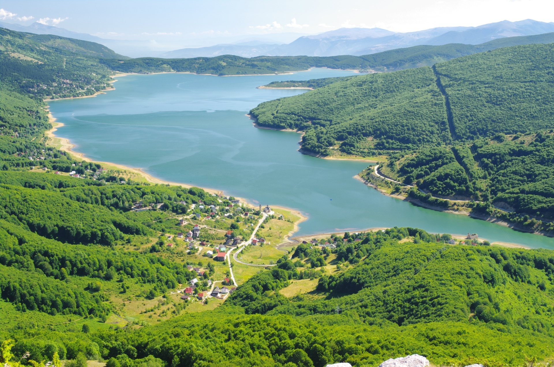 Aerial view of turquoise Lake Mavrovo and surrounding forested hills