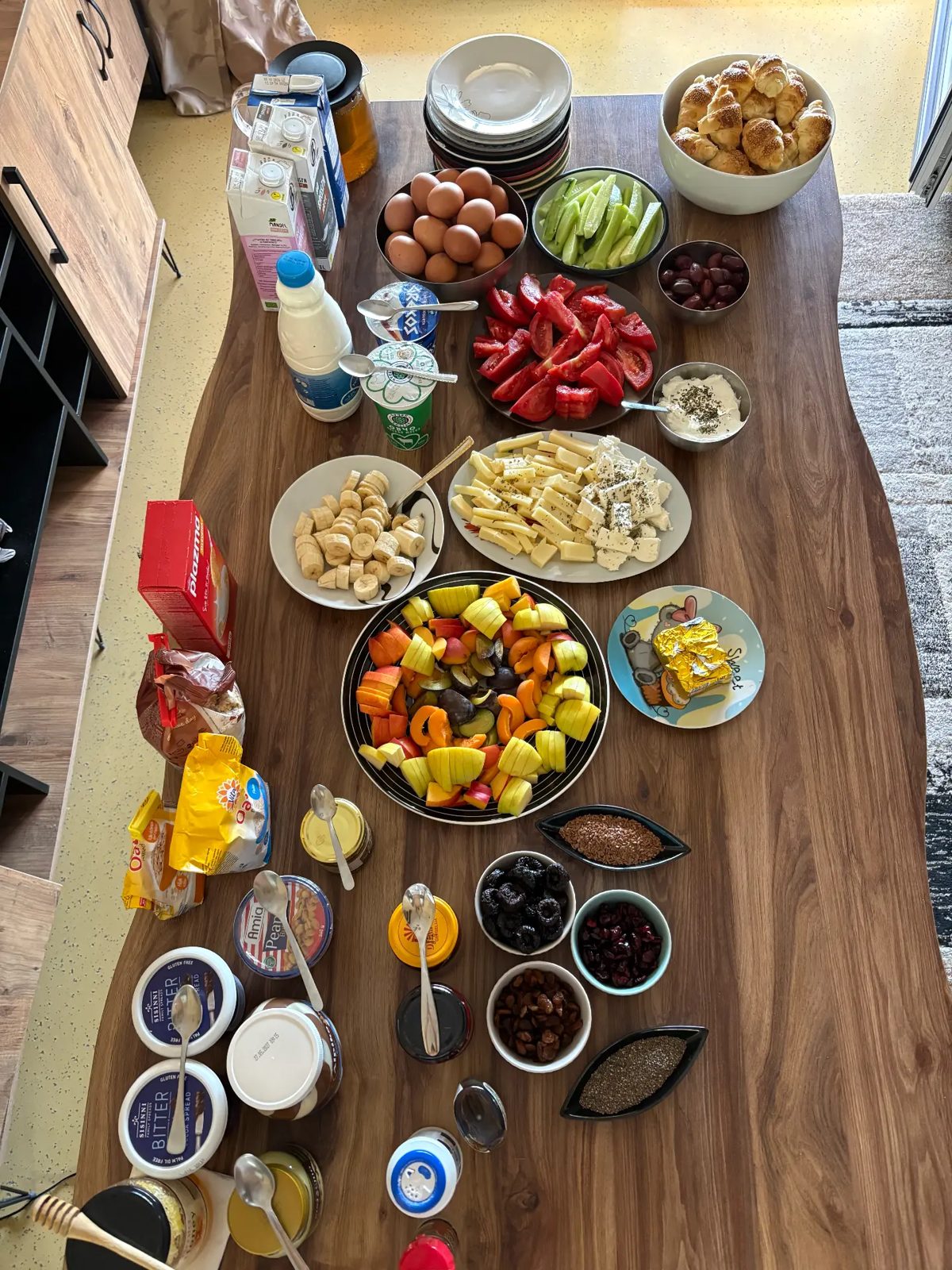 Long breakfast table full of fresh food