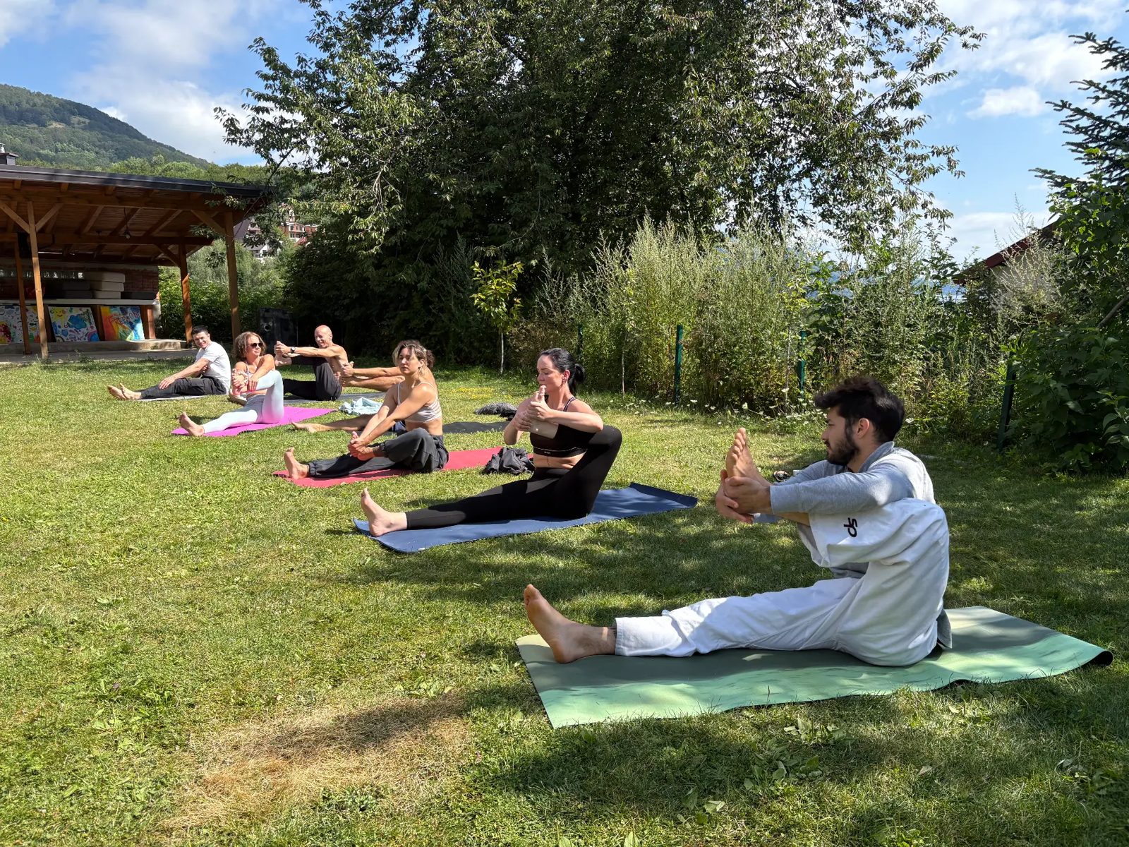 Stretch class on mats in the garden
