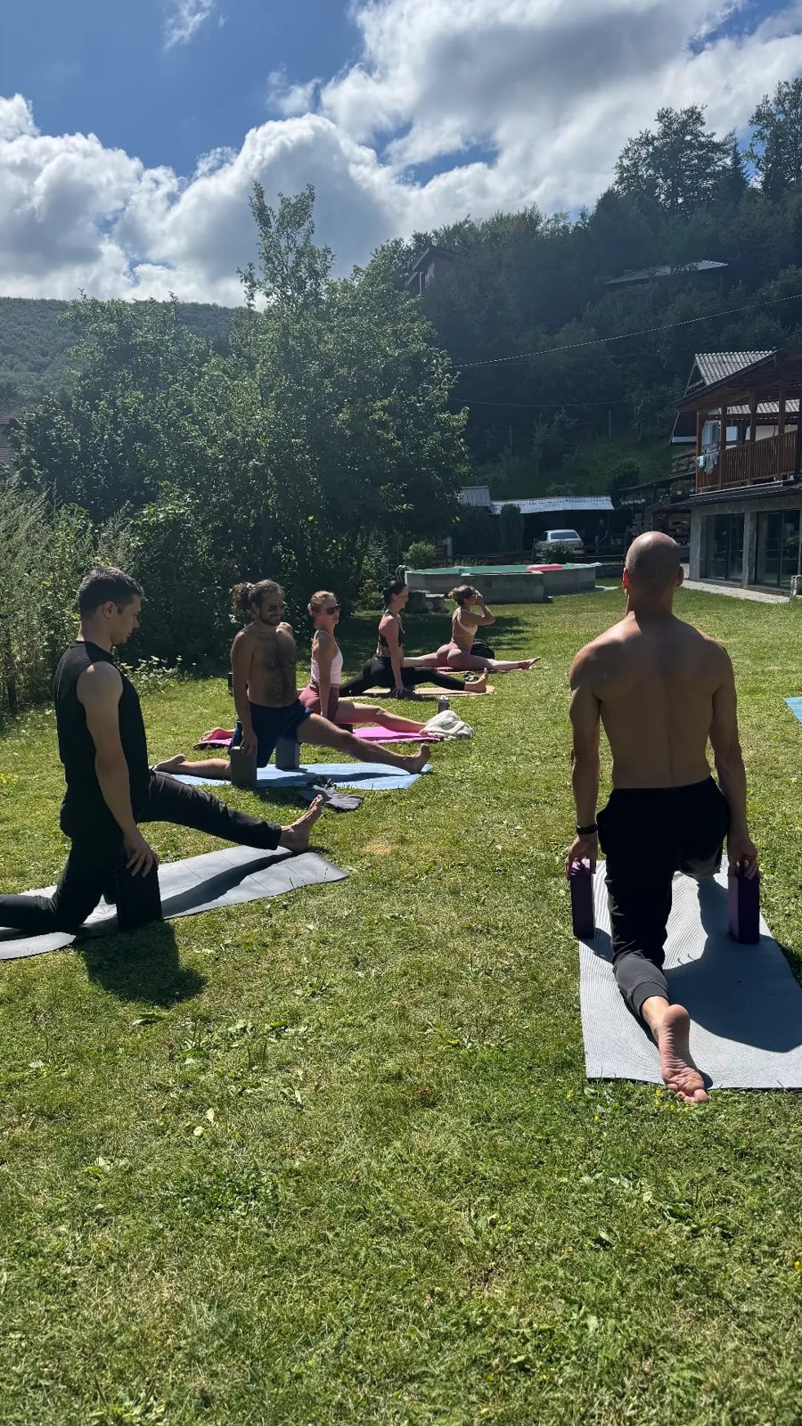 Morning movement class on the grass at the villa