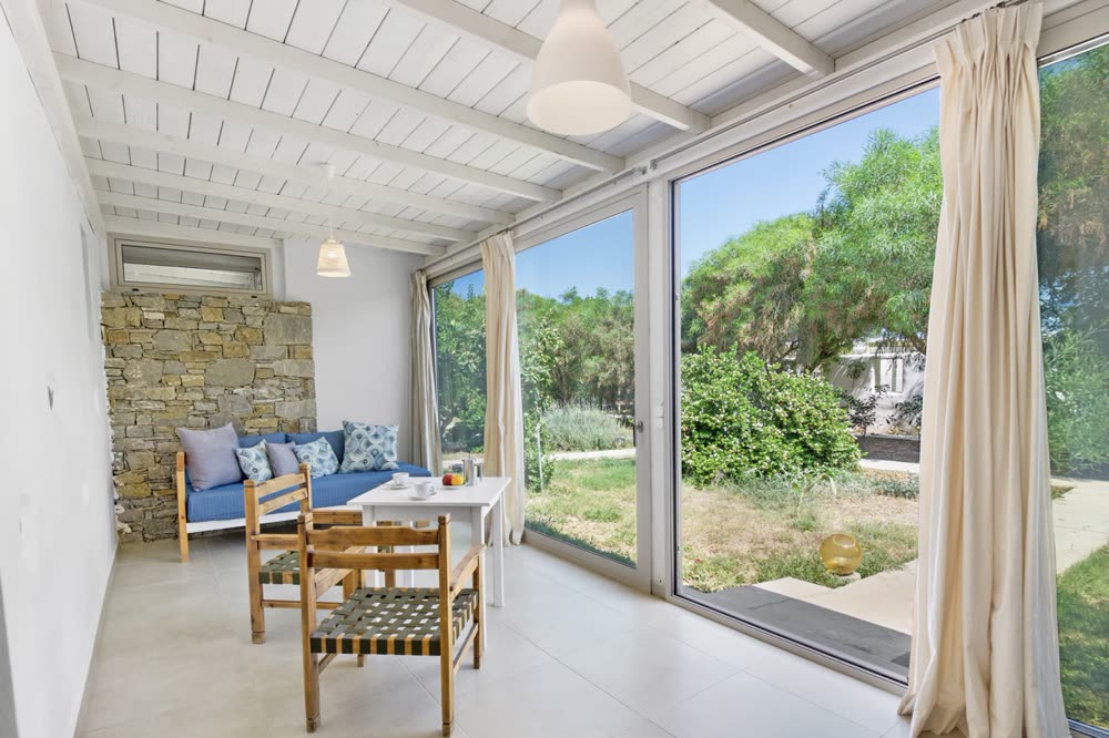 Sitting area opening onto the garden through glass doors