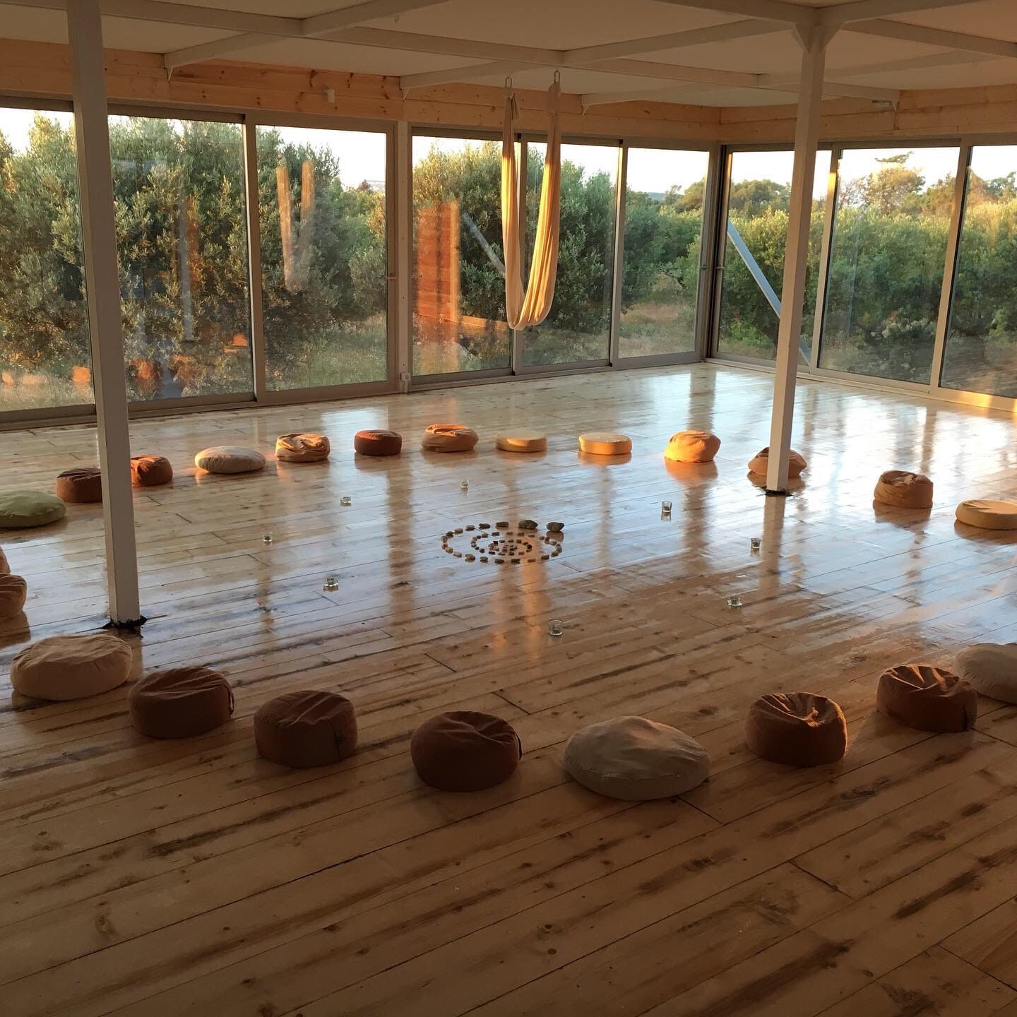 Shala set up for meditation with cushions in a circle