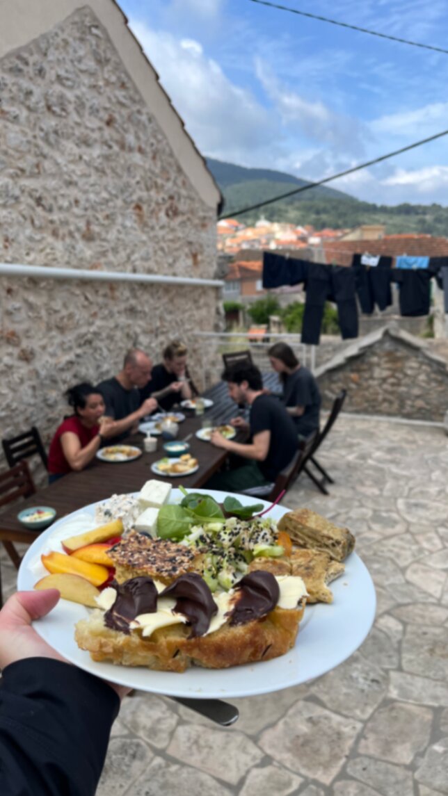 Plate of food with the group dining in the background
