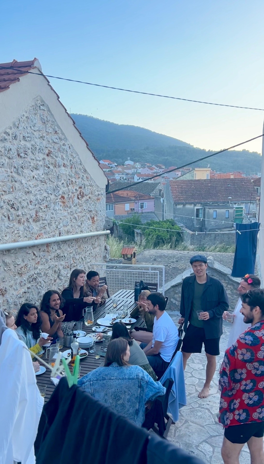 Long-table dinner on a Korčula terrace at dusk