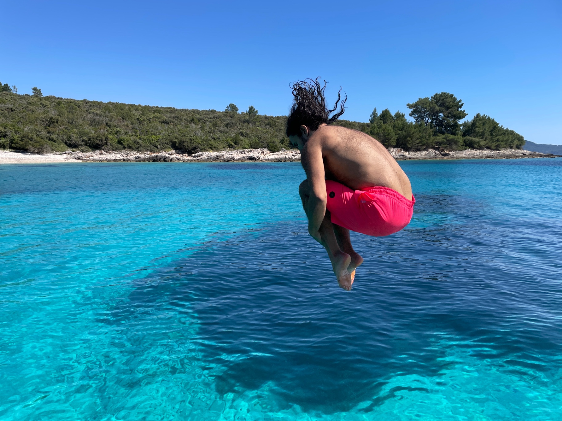 Jumping into the turquoise Adriatic sea